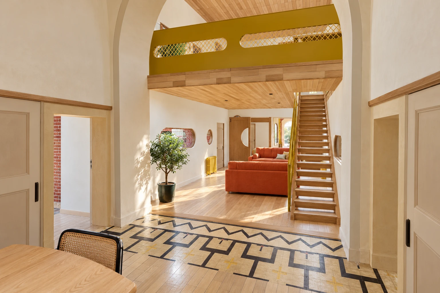 Le séjour et l’escalier, sous l’arche · rendu du futur gîte